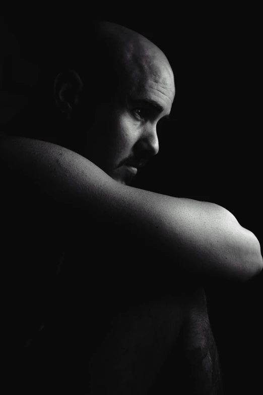 man in black shirt with arm folded on his chest