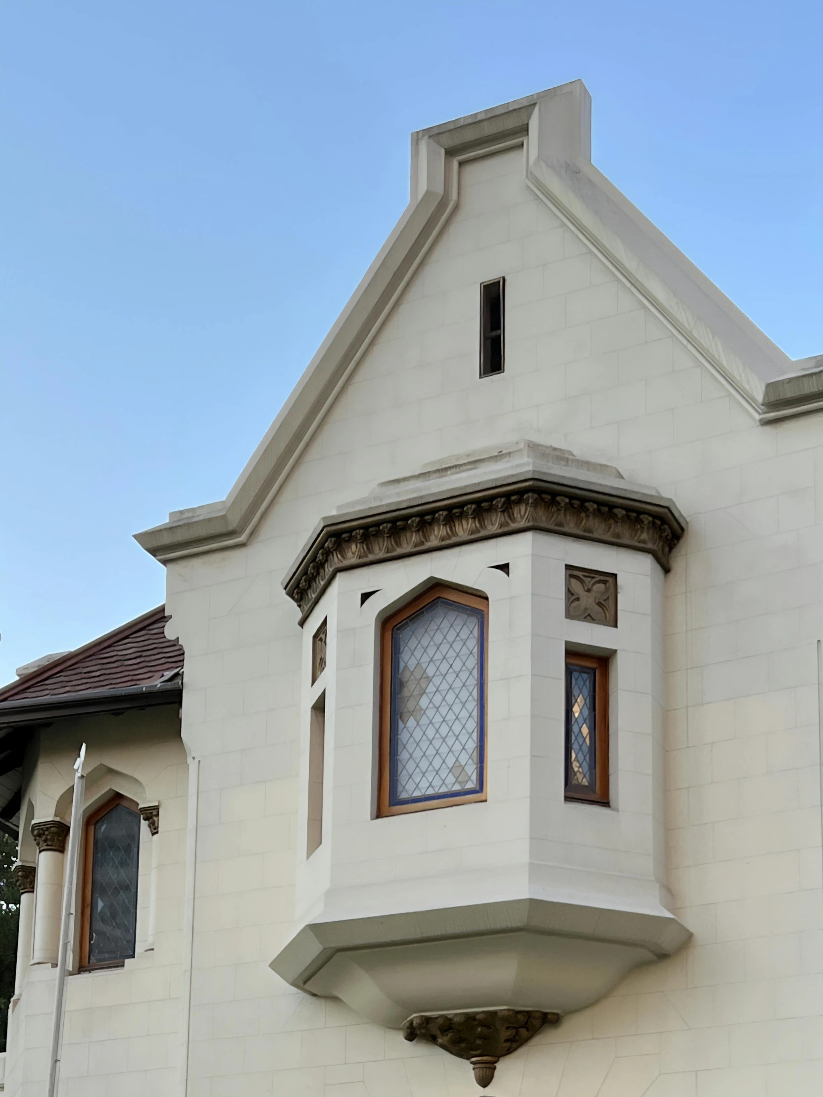 a white building with windows and a window on the top