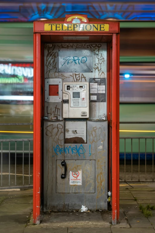 an old, rusty atm machine that has been vandalized