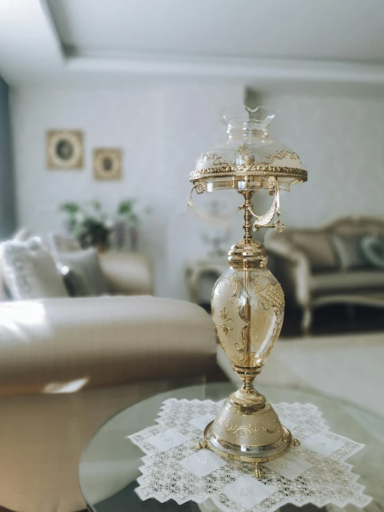 small gold candle holder on glass table in a living room