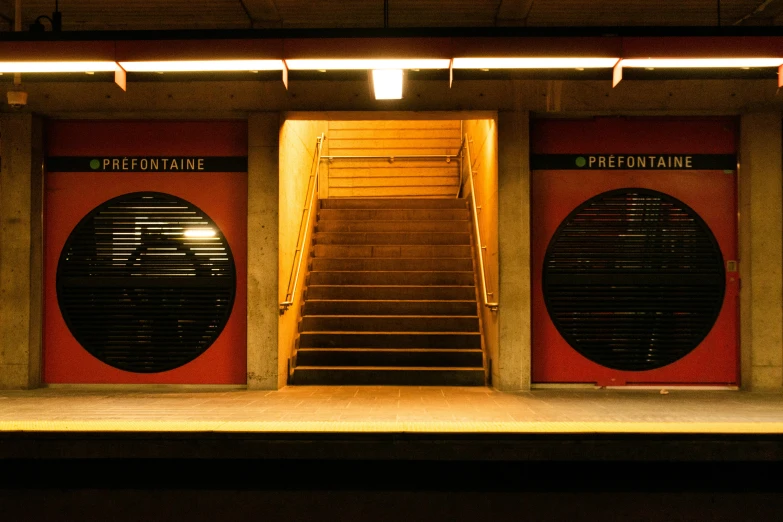 a red stage with three separate open space doors and stairs