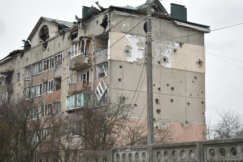 a view of an old building with a lot of windows and a rusted telephone pole