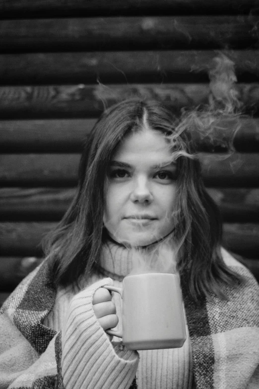 a black and white image of a woman drinking coffee
