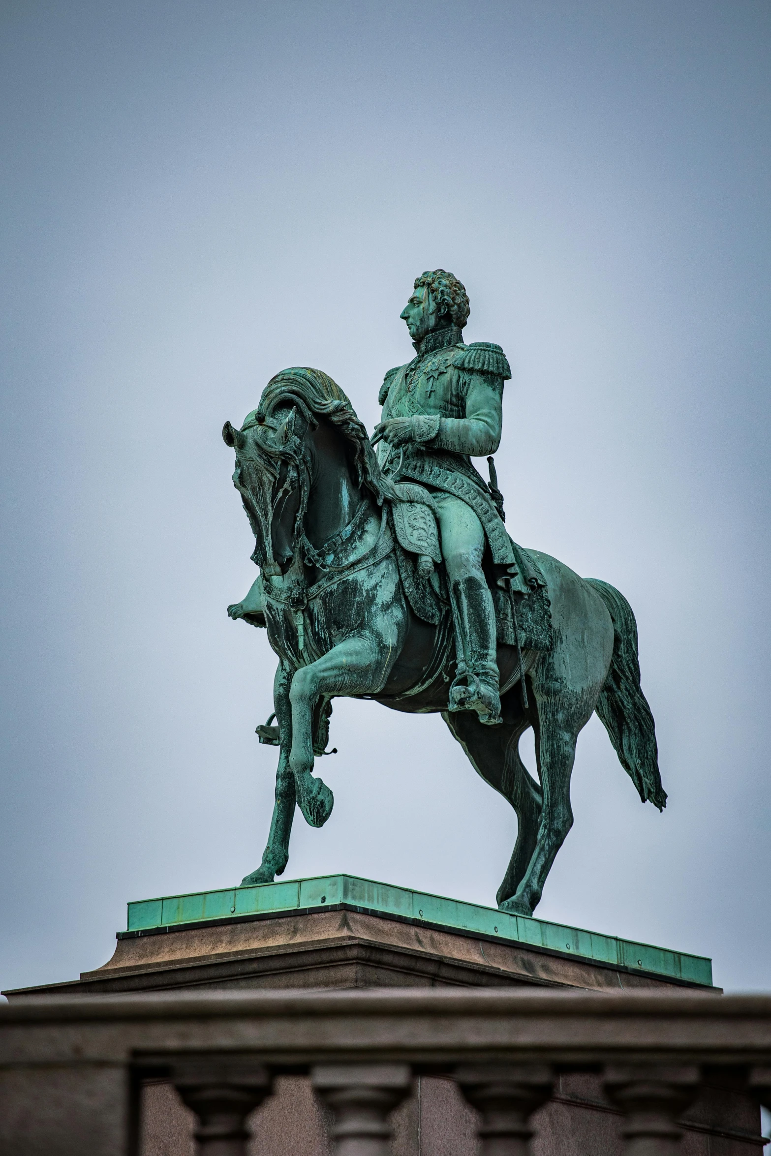 a large bronze statue of a man sitting on a horse