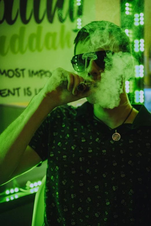 a man with glasses and a cigarette in front of green lights