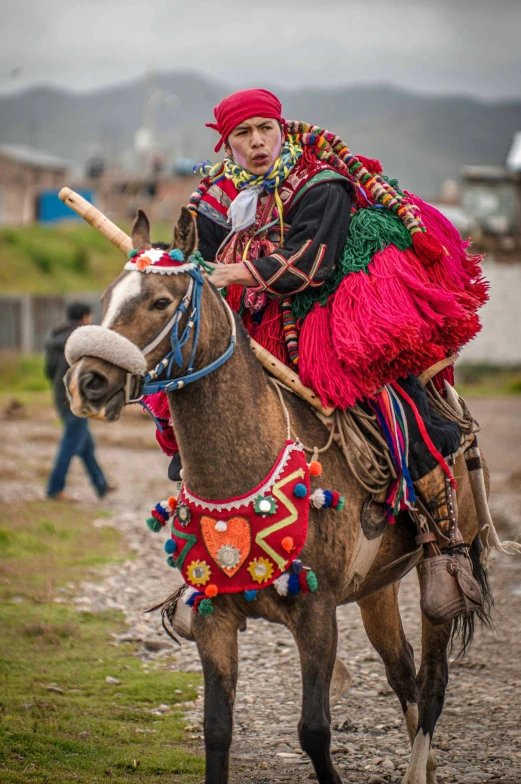 a child dressed in traditional costume riding on a horse