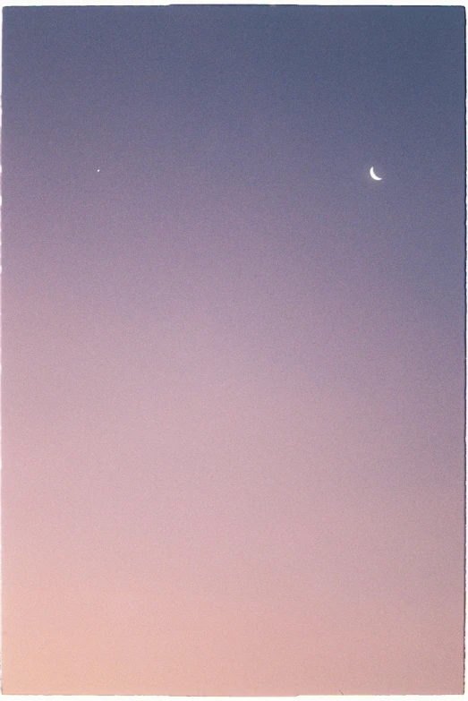 a clear blue sky with the moon in the distance