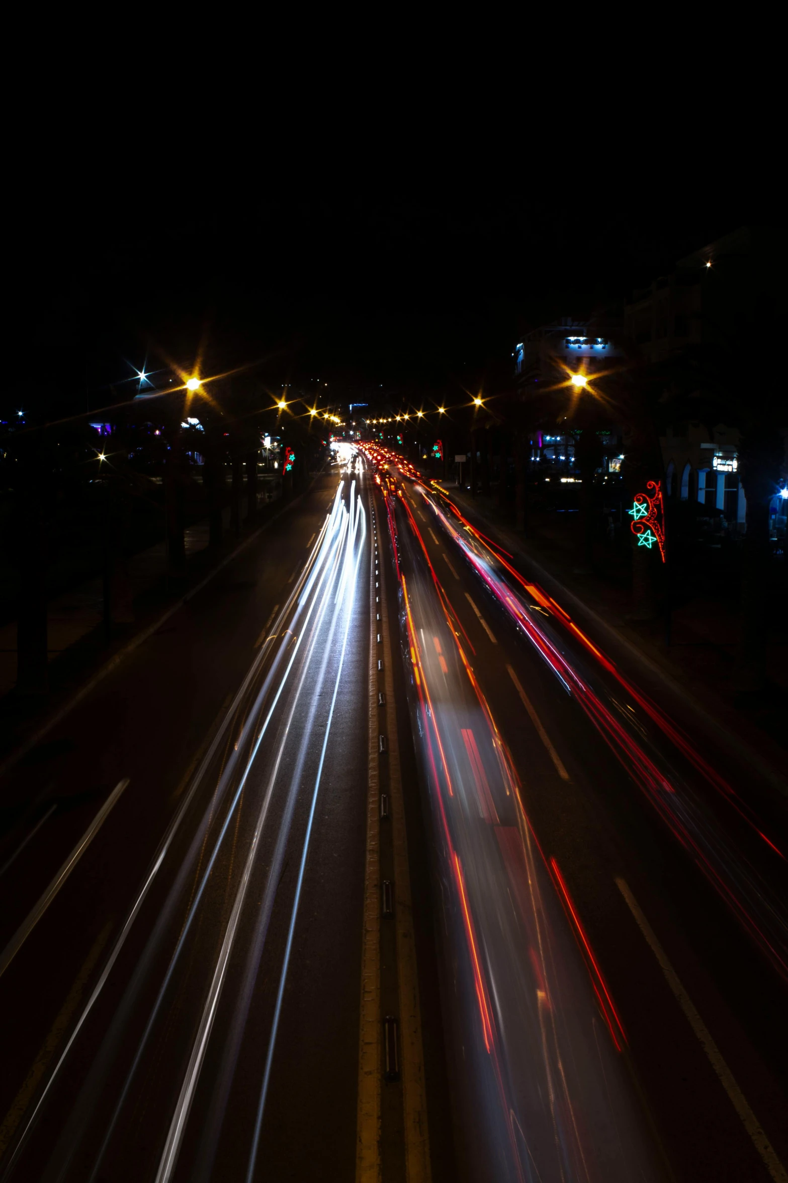 cars on a freeway with some light trails from them