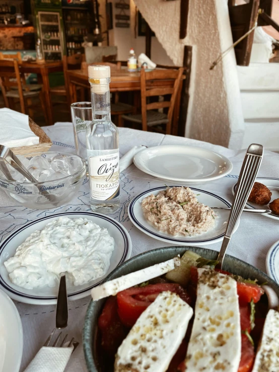 a white table topped with plates and silverware