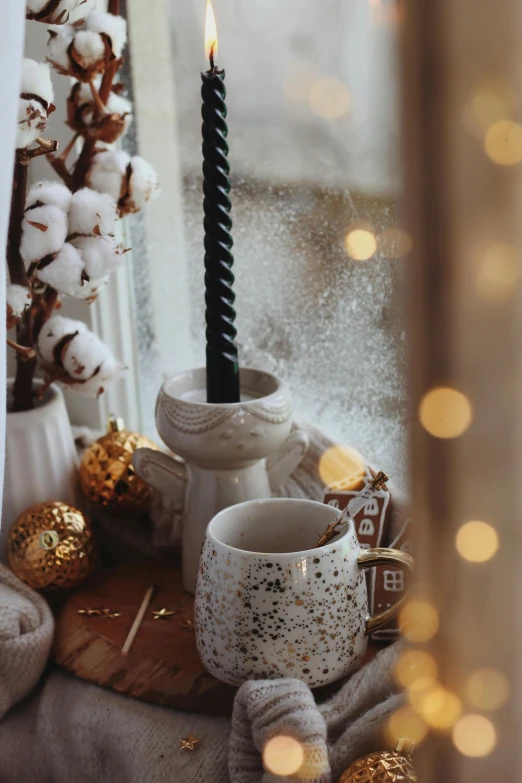 a single candle burning on the windowsill