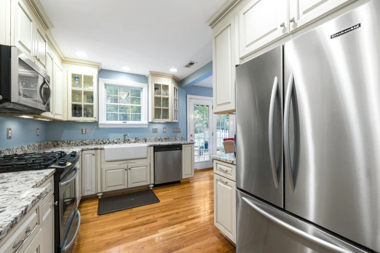 a clean kitchen is equipped with appliances and granite counter tops