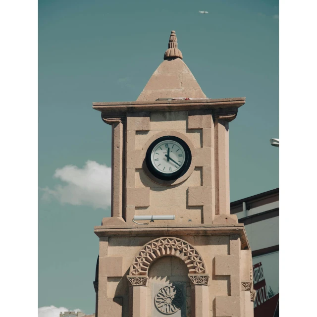 an old building with a clock in the middle of the roof