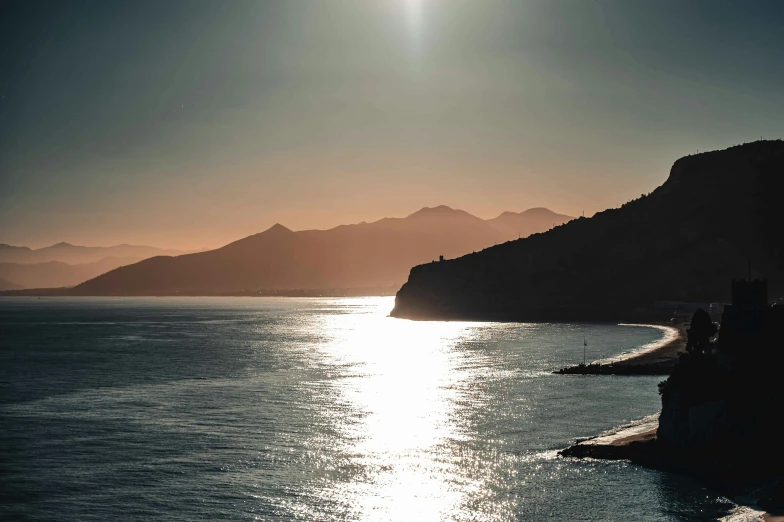 a view of the ocean with a mountain in the background