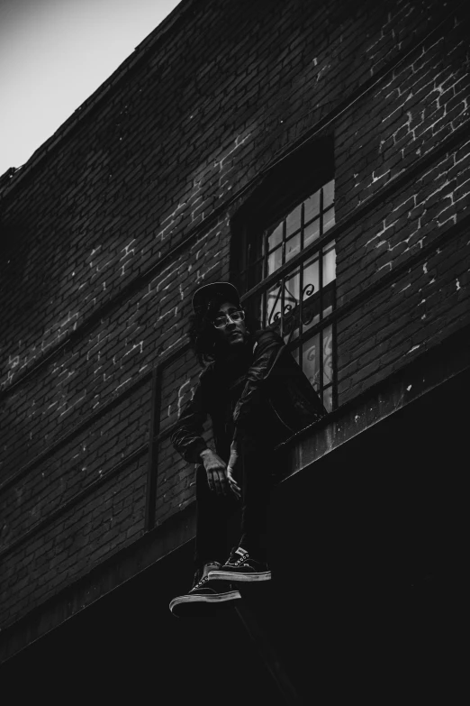 a person jumping a snowboard into the air near a building