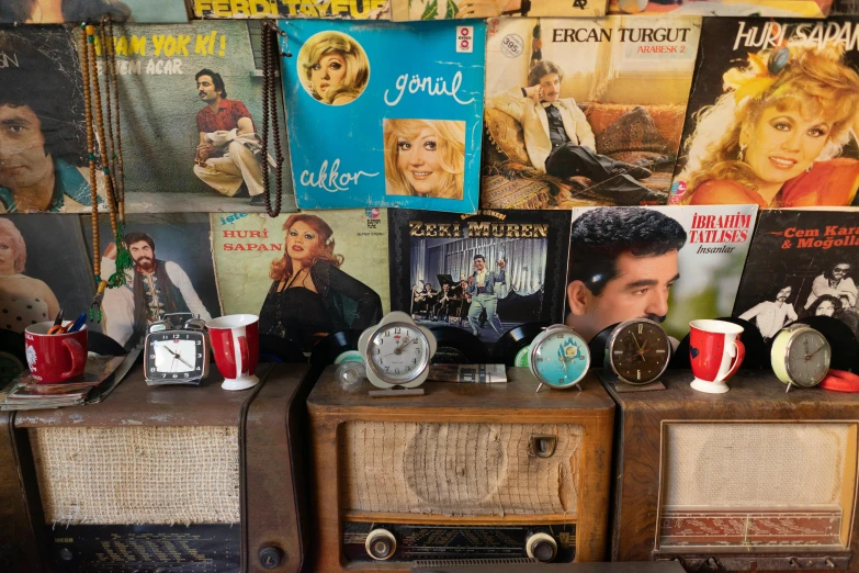 man looking at some old time radio, record player and magazines