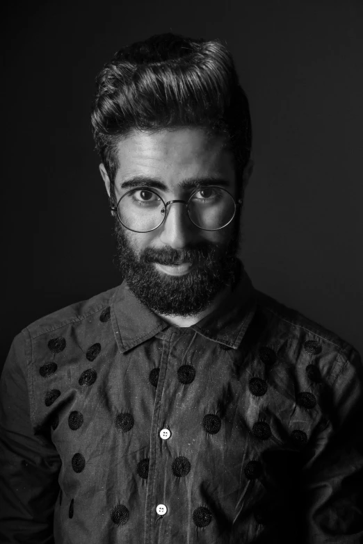 black and white po of a man wearing glasses and a beard