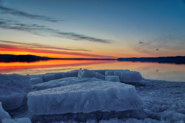 a lake is covered in ice during the day