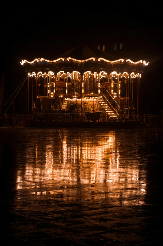 a carnival ride with lights and decorations on the side