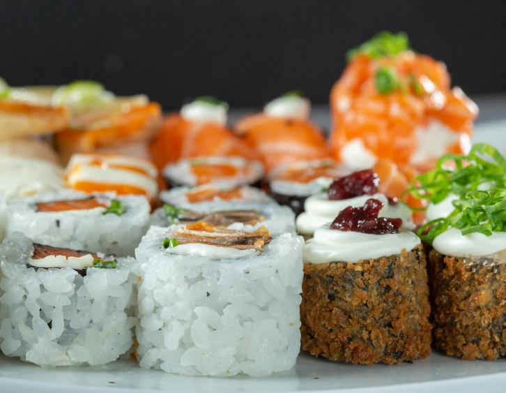 a plate topped with sushi and other food