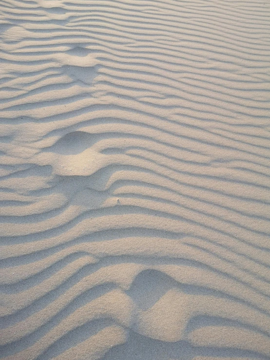 a sand dune texture with some patterns in the sand