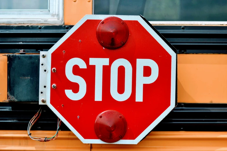 a stop sign hanging on the side of a bus