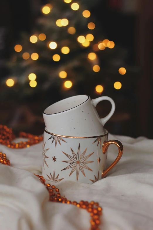 a tea cup is sitting on a blanket next to a tree