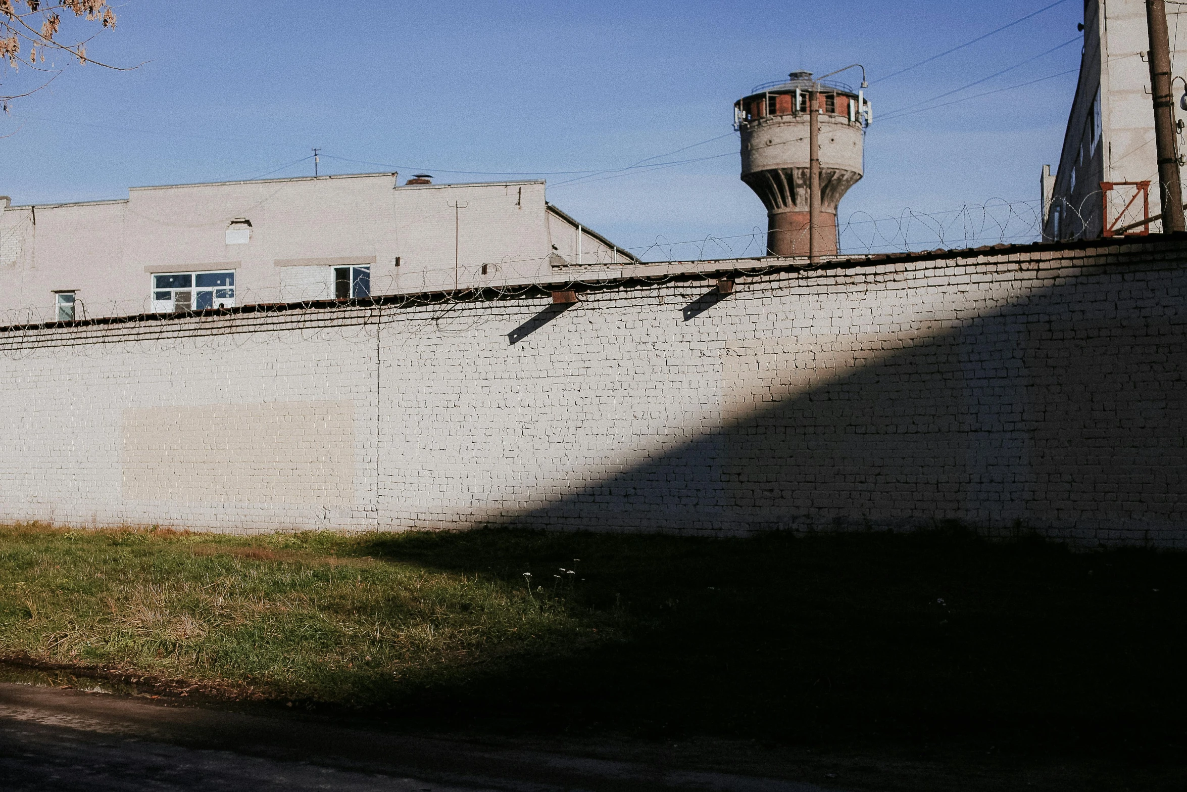 a cement wall next to a building and a building with a tower