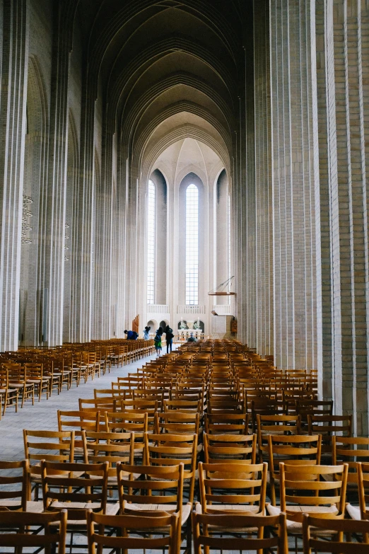 there are many wooden chairs in this cathedral