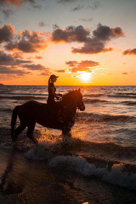 the person is riding a horse through the water