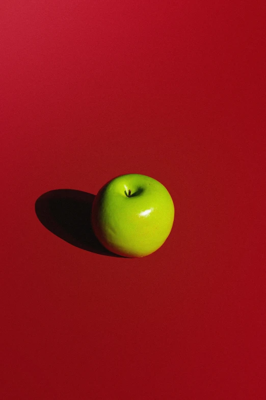 an apple is on a red surface with no image