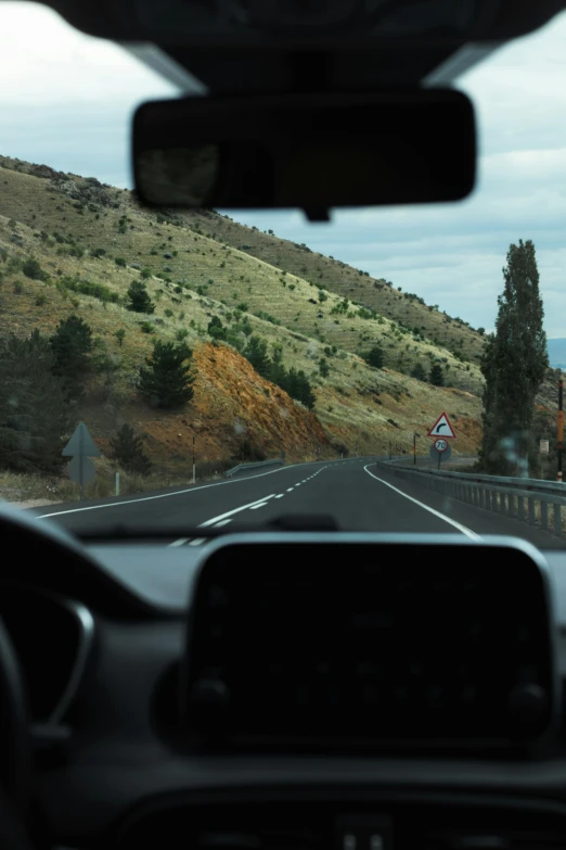 view from inside a car looking out on a scenic mountain