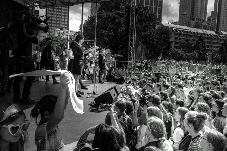 a crowd of people is standing on the street