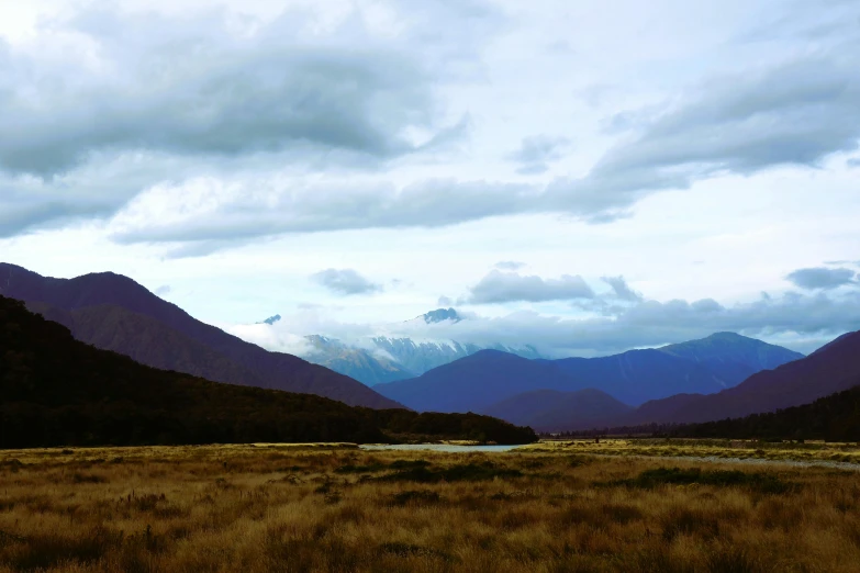 the view of a mountain range and the valley behind