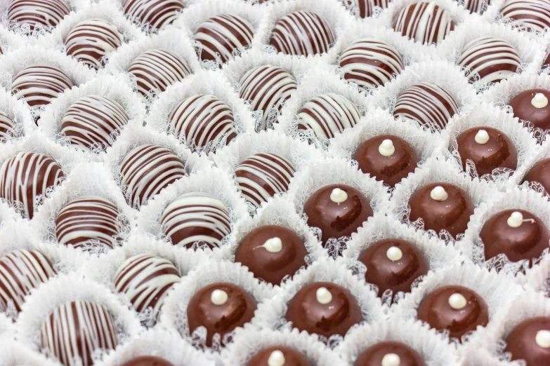 chocolate truffles with white heart shapes on them