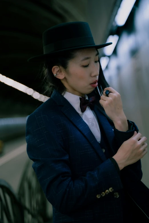 a man dressed in a suit and a top hat with a cellphone to his ear