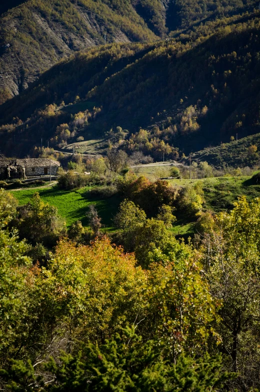 there is a lush green mountain range with mountains in the distance