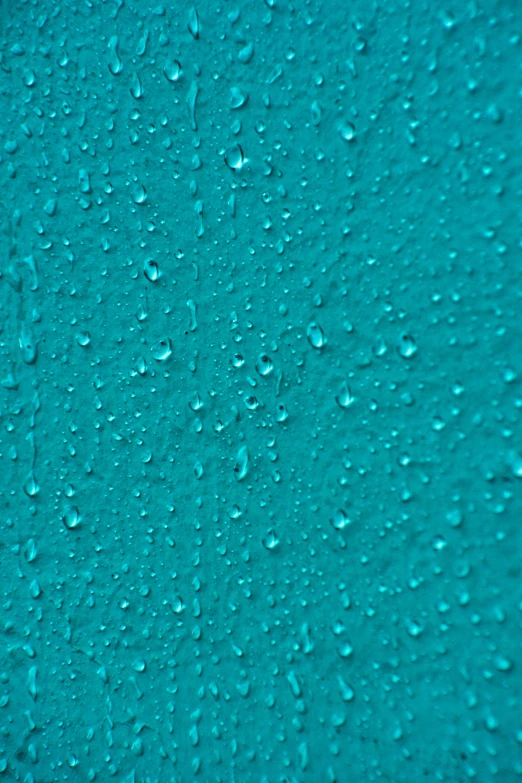 water drops falling down onto the blue background