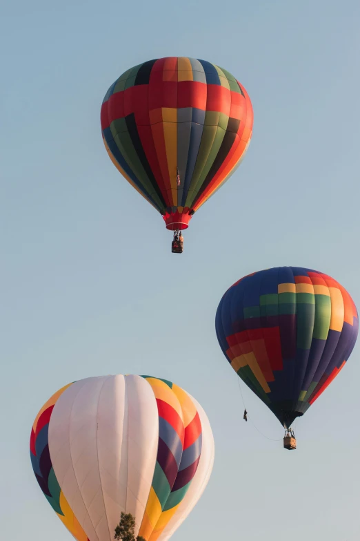 three  air balloons in the sky above