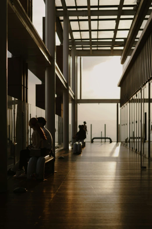 people sit and look out over the ocean at sunrise