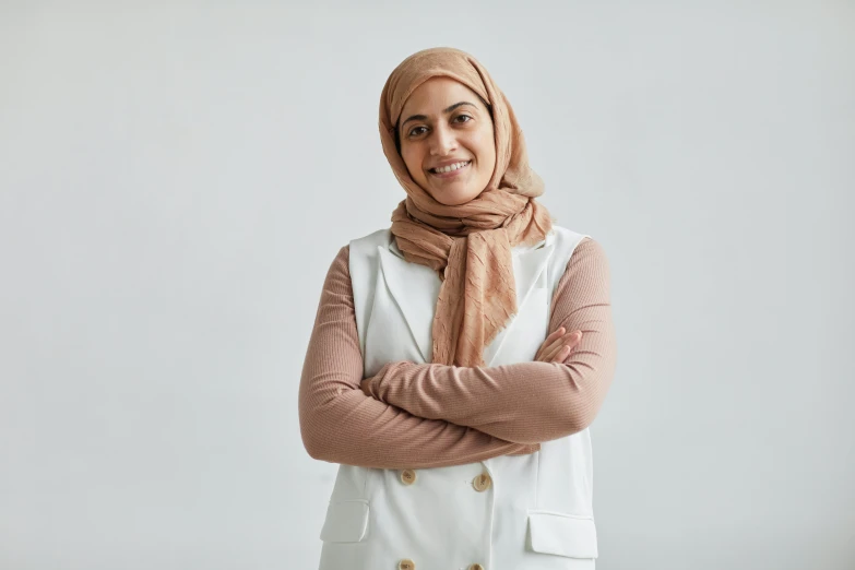 a woman wearing a scarf and white top posing for a portrait