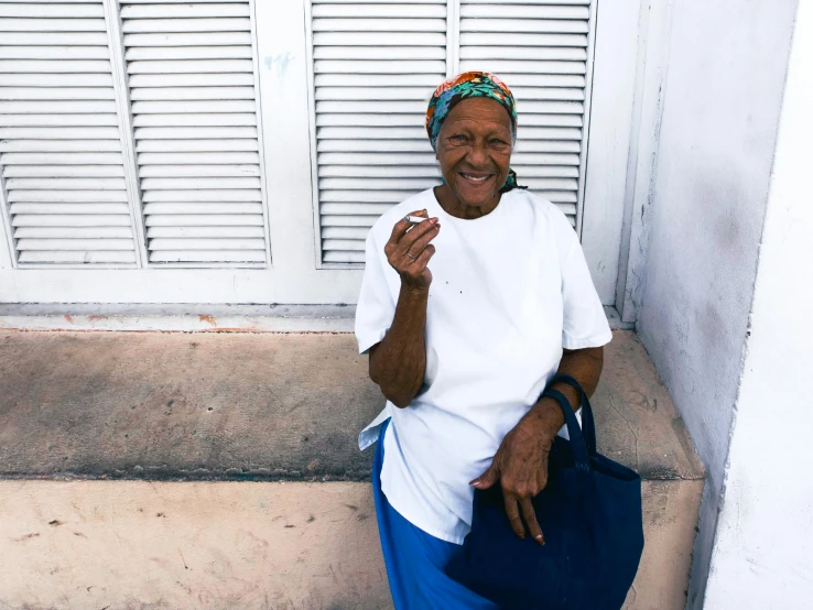 a woman smiling and sitting on some steps