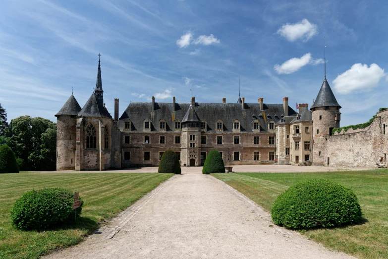 a castle that is in the middle of some grass