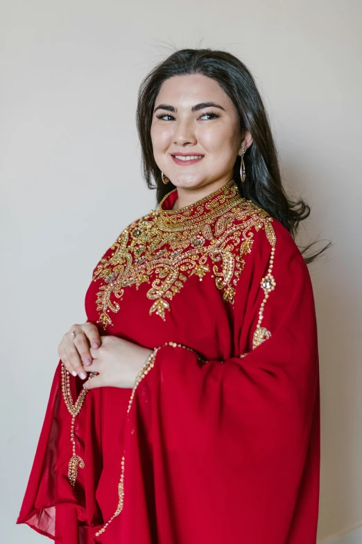 woman in red dress with shawl on wall