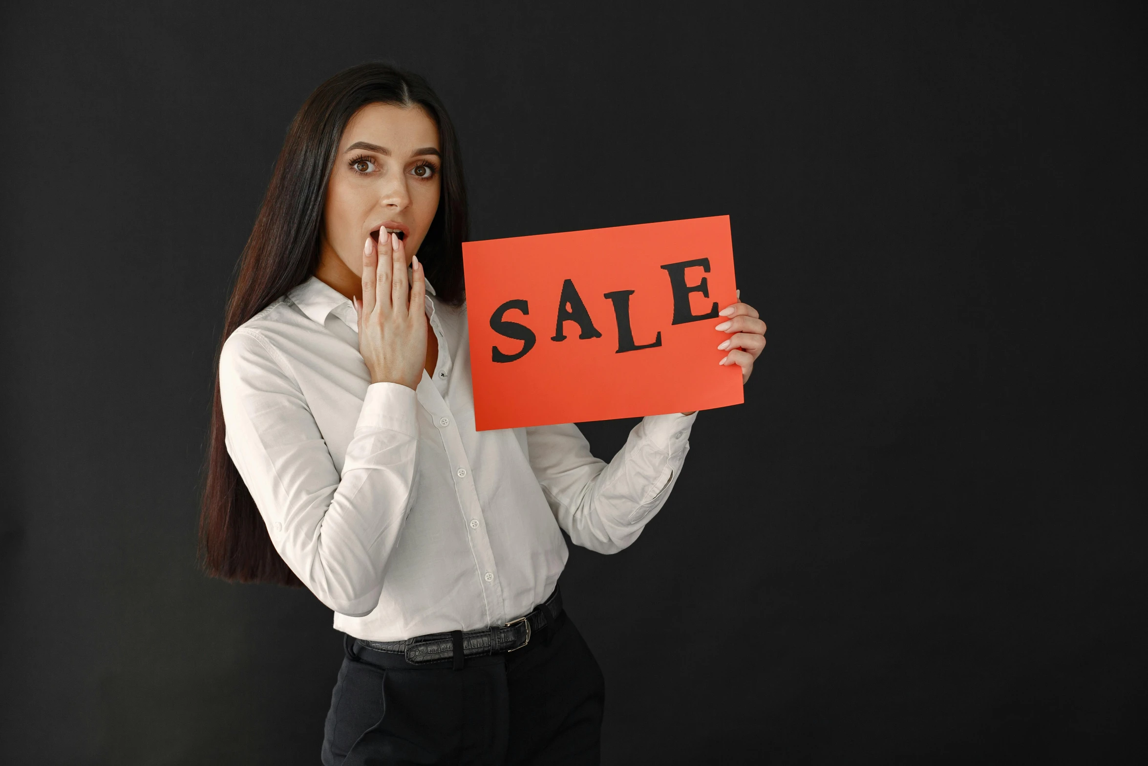 a woman holding up an orange sign with the words sale