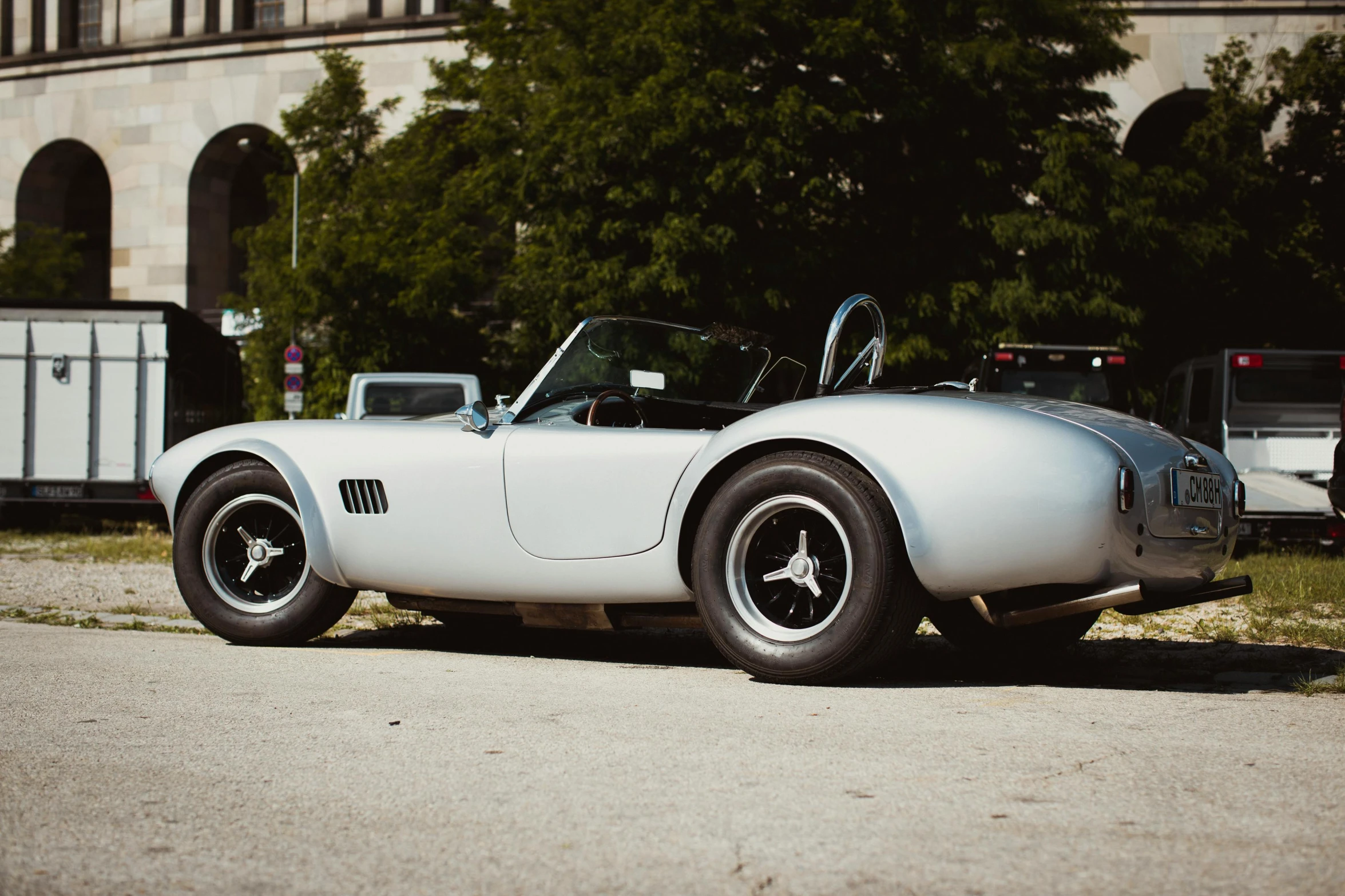 a white race car sits parked in a lot