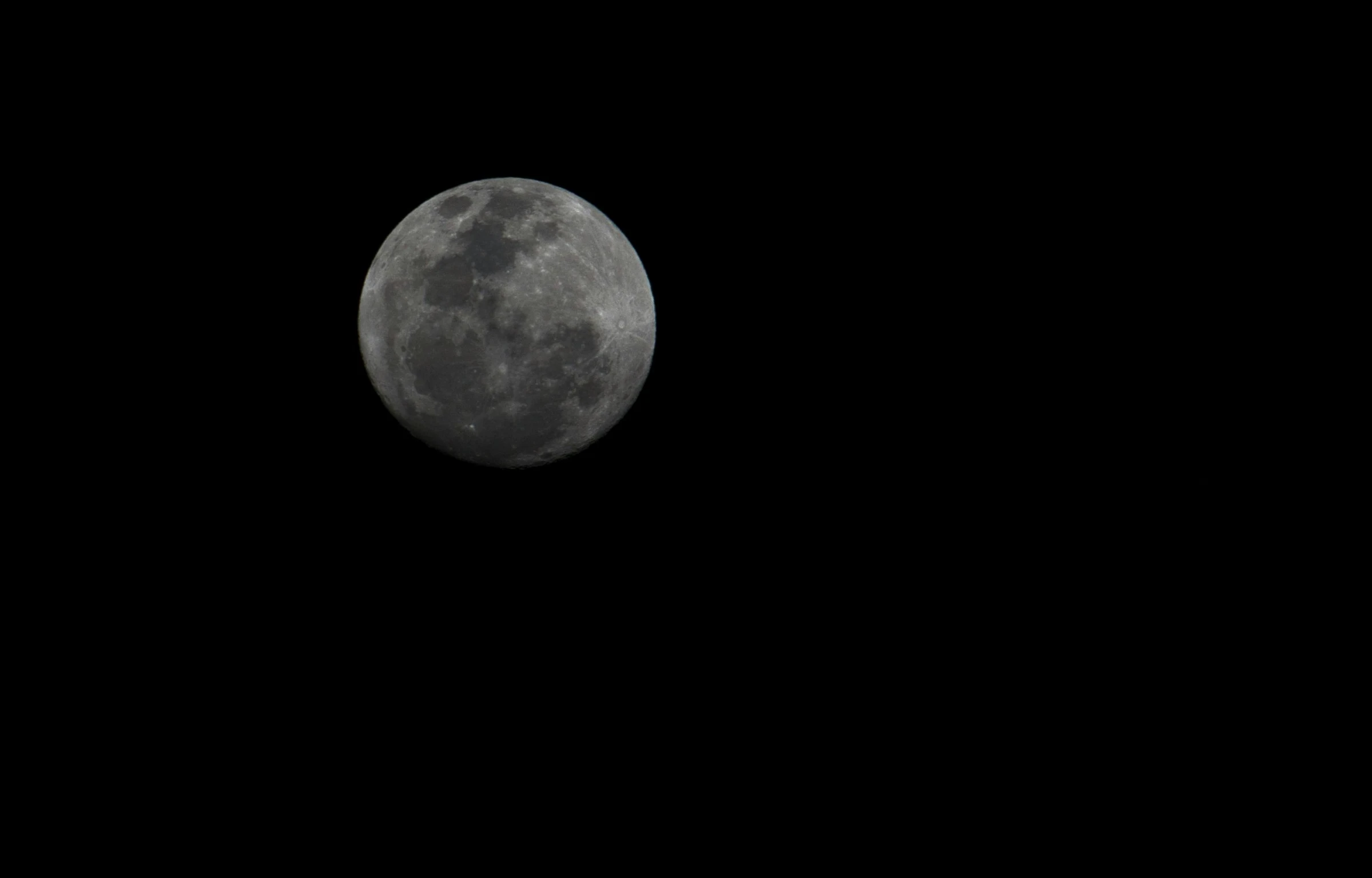 the moon is seen in a black sky