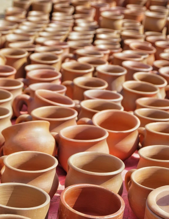 many clay bowls lined up in rows for sale