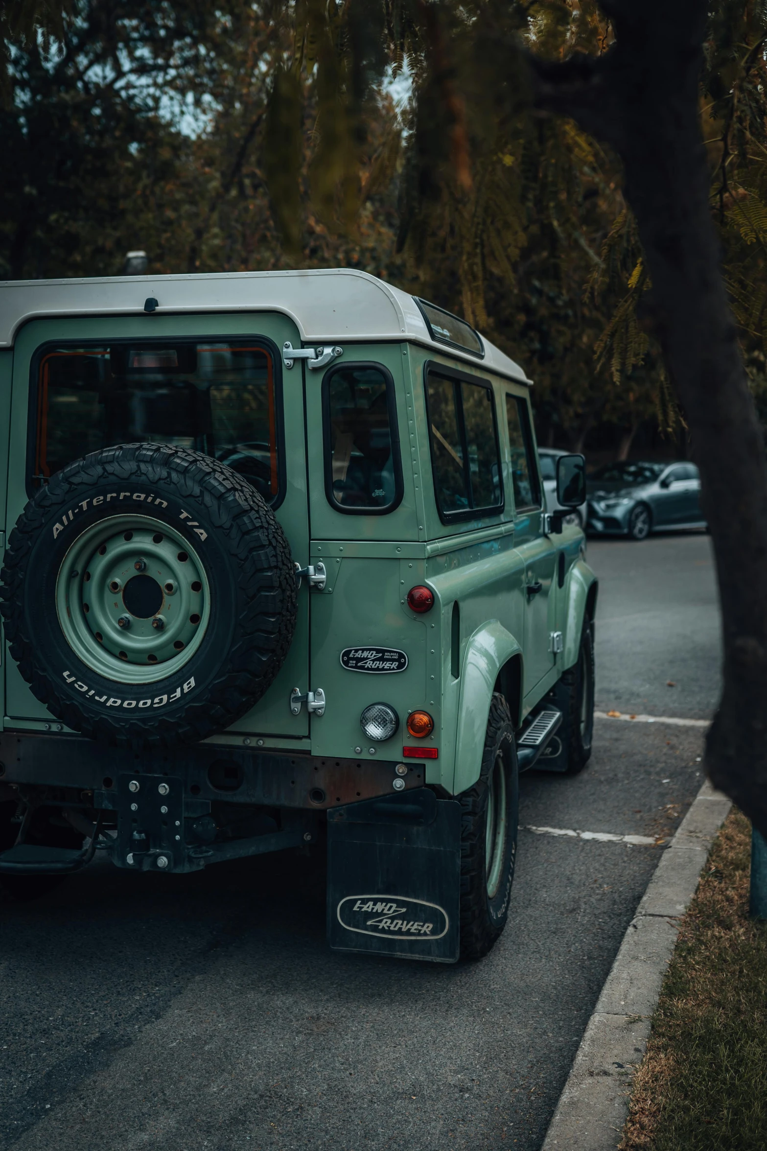 green jeep is parked next to the curb