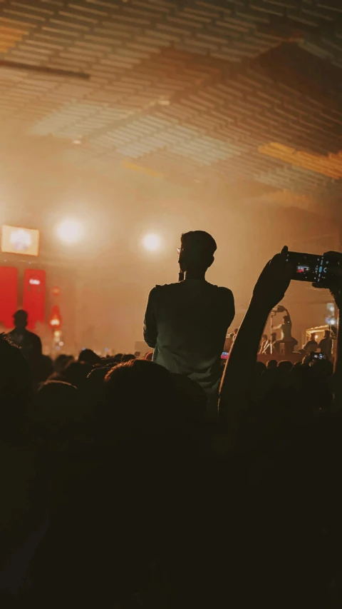 two people taking pos at a concert