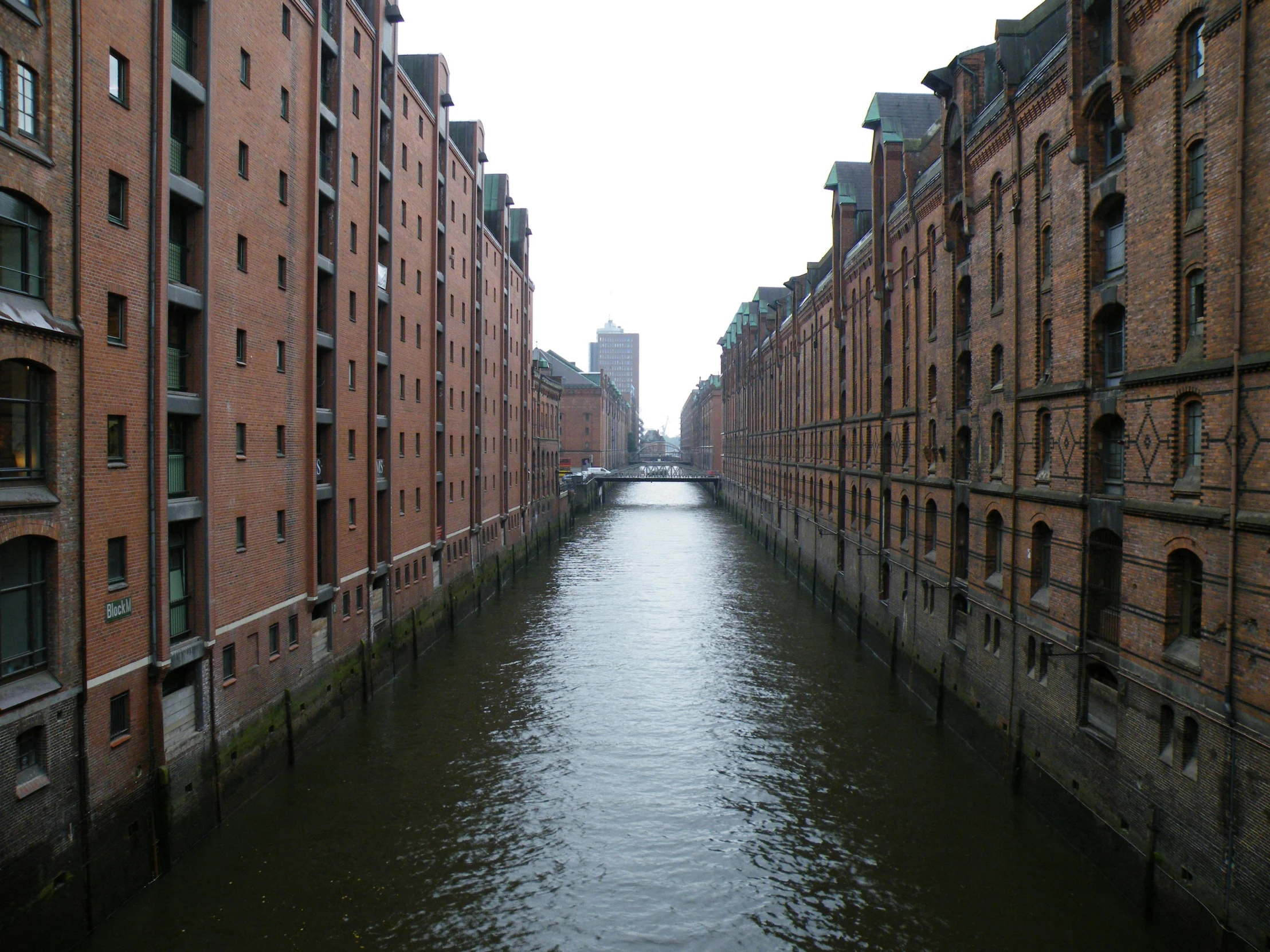 a view of the canal from an alley in old buildings